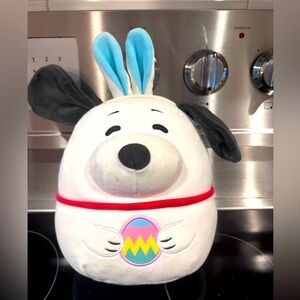 The Squishmallows Peanuts Easter Bunny Snoopy is an 11- inch medium-sized Peanut